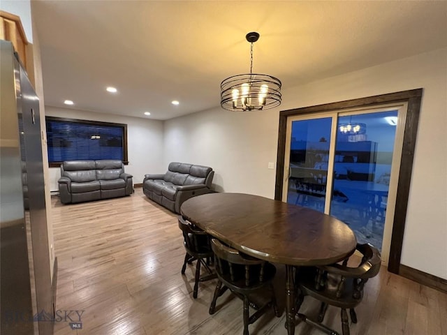 dining area featuring a chandelier and hardwood / wood-style floors