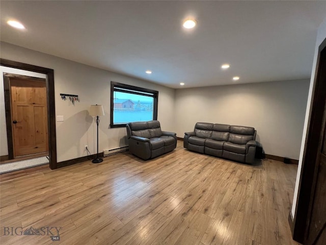 living room featuring light hardwood / wood-style flooring and a baseboard radiator