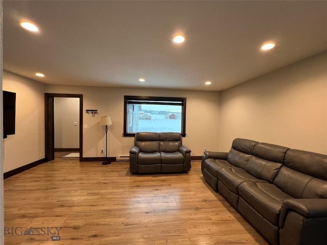 living room featuring baseboard heating and light wood-type flooring