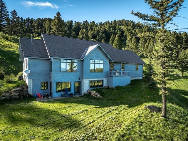 rear view of house featuring a lawn