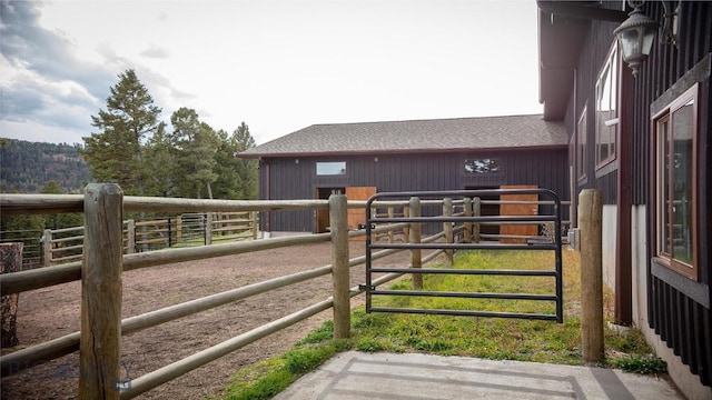 view of gate with an outbuilding