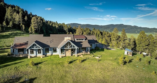 view of front of property with a mountain view and a front lawn