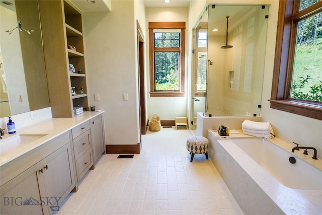 bathroom featuring vanity and plus walk in shower