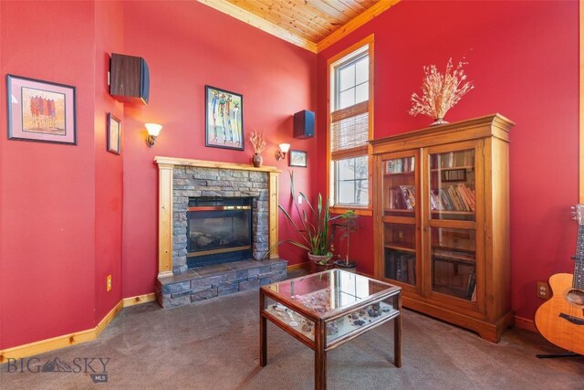 carpeted living room featuring a high ceiling, ornamental molding, and a fireplace