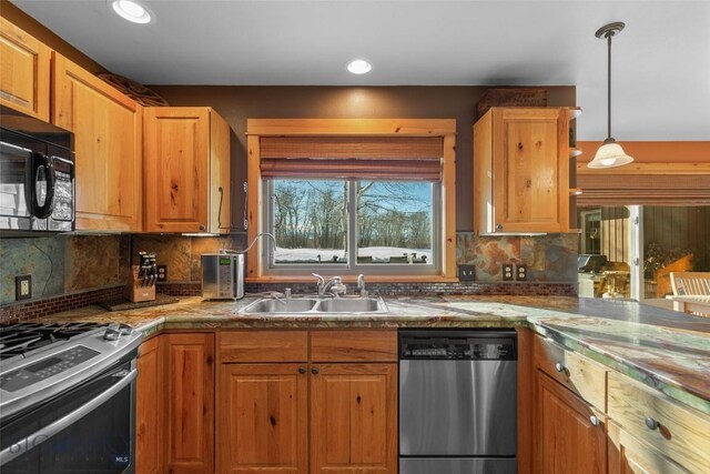 kitchen featuring hanging light fixtures, decorative backsplash, sink, and stainless steel appliances