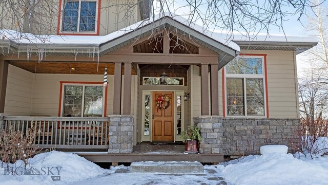 view of snow covered property entrance