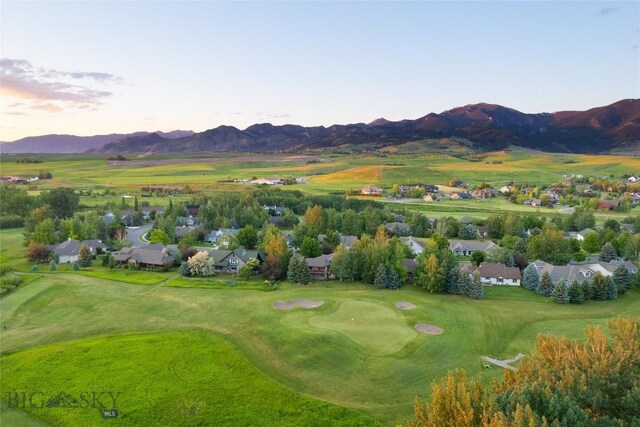 aerial view at dusk featuring a mountain view