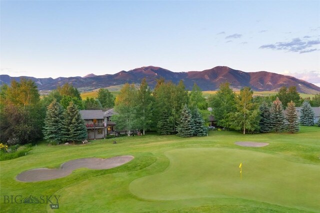 surrounding community featuring a mountain view and a lawn