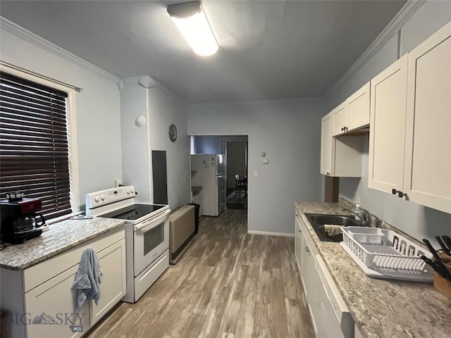 kitchen with light stone countertops, sink, white appliances, and light hardwood / wood-style flooring