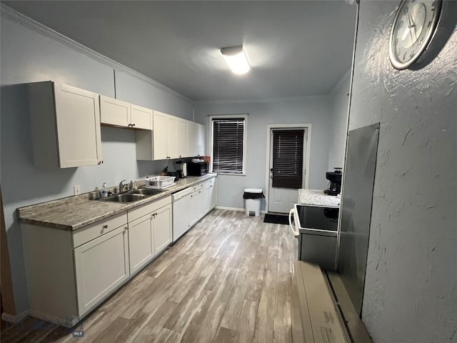 kitchen featuring dishwasher, sink, crown molding, and white cabinetry