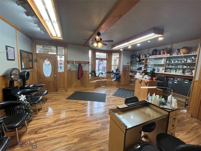 office area with ceiling fan, hardwood / wood-style floors, and wooden walls