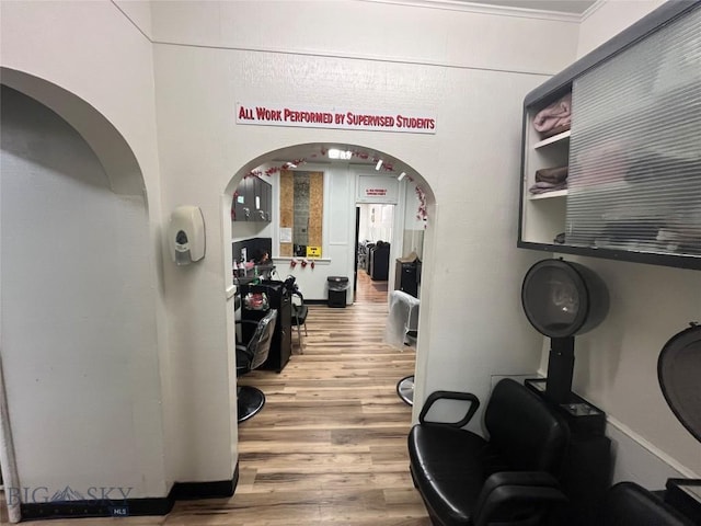 workout area with hardwood / wood-style flooring and ornamental molding