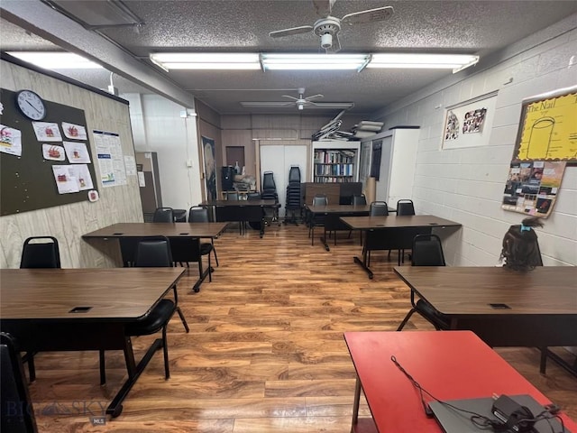 office area with ceiling fan, hardwood / wood-style floors, and a textured ceiling