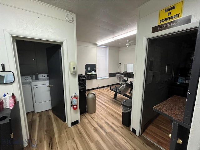 interior space featuring washing machine and dryer, ceiling fan, and hardwood / wood-style flooring