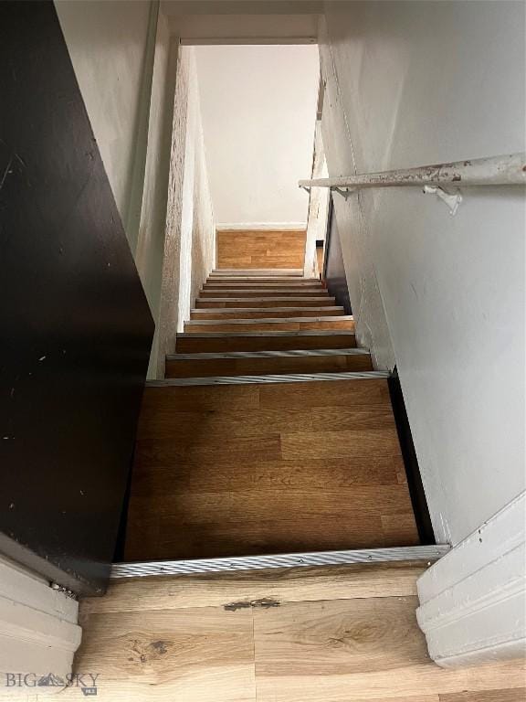 stairs with hardwood / wood-style flooring