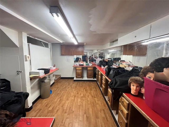 kitchen with light wood-type flooring and dark brown cabinetry