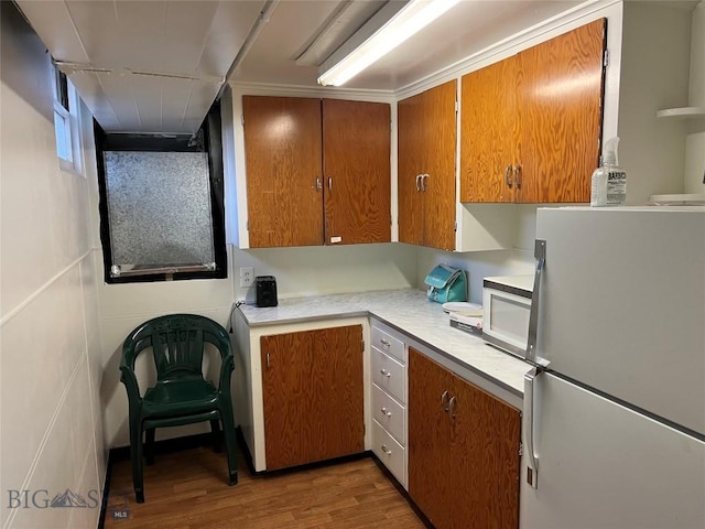 kitchen featuring white appliances and hardwood / wood-style flooring