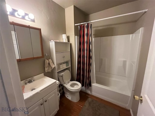 full bathroom with shower / bath combo with shower curtain, hardwood / wood-style flooring, vanity, and toilet