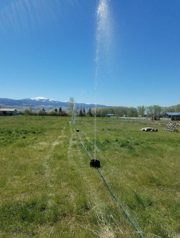 view of yard featuring a rural view and a mountain view