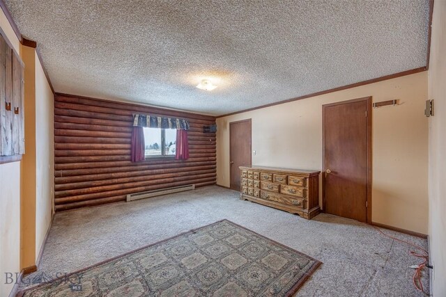 unfurnished bedroom featuring carpet, ornamental molding, a textured ceiling, baseboard heating, and rustic walls