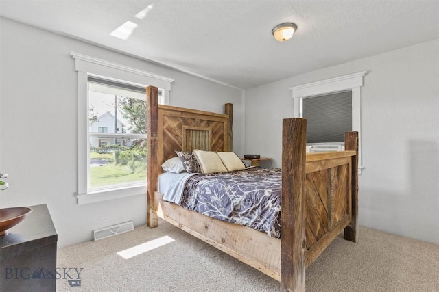 carpeted bedroom featuring a textured ceiling