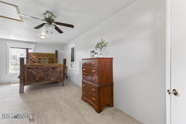 carpeted bedroom with ceiling fan and a textured ceiling