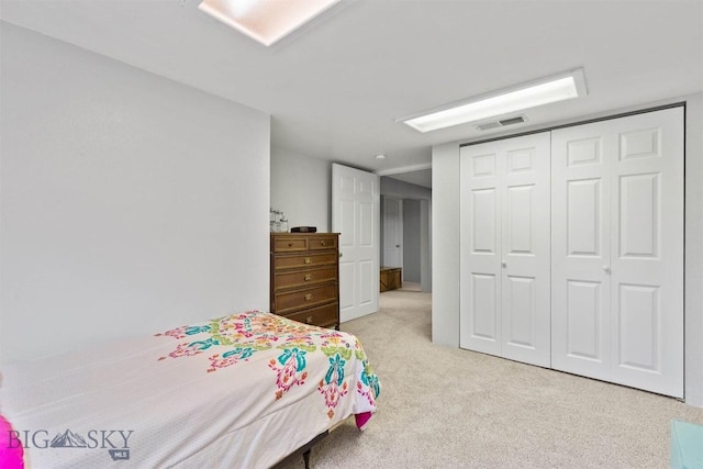 bedroom featuring a closet and light carpet