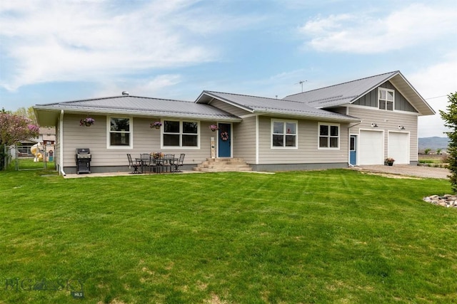 rear view of house with a patio and a lawn