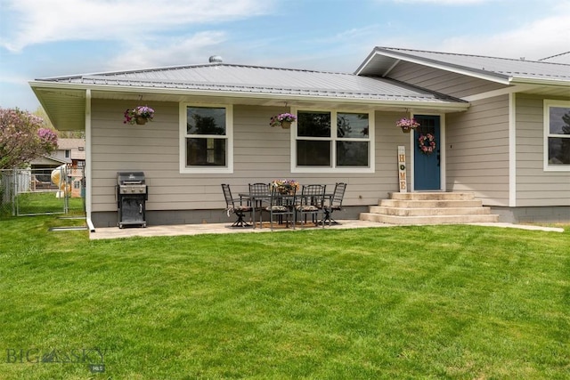 back of property with a yard and a patio