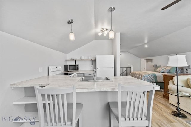 kitchen with sink, hanging light fixtures, white refrigerator, kitchen peninsula, and electric stove