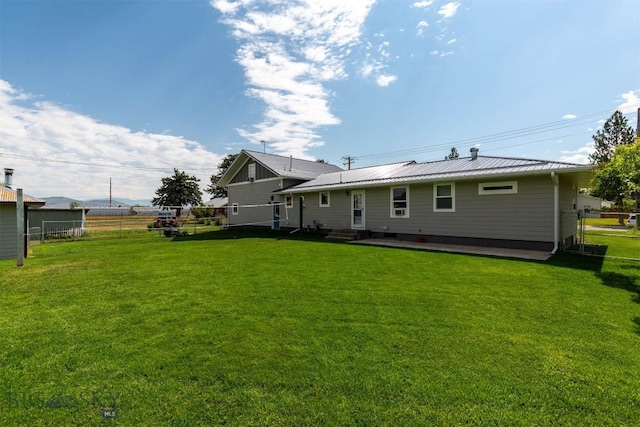 rear view of house with a yard