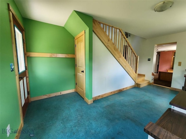 unfurnished living room with dark colored carpet