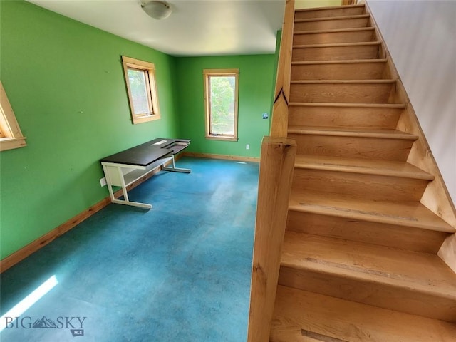 stairs with concrete flooring