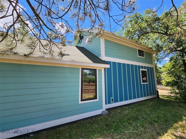 view of side of property with a lawn