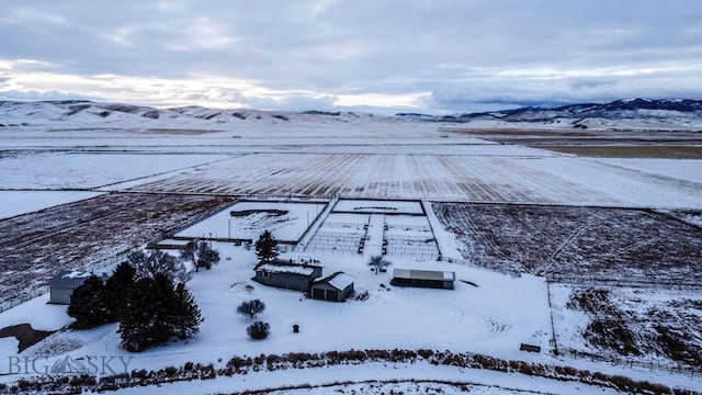 snowy aerial view featuring a mountain view