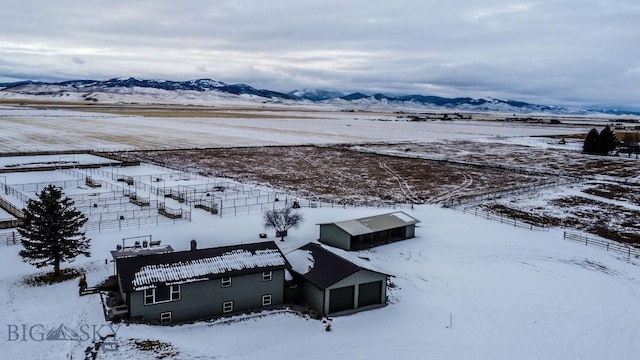 snowy aerial view featuring a mountain view