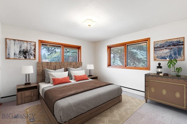 carpeted bedroom featuring a baseboard heating unit