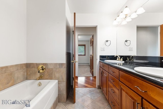 bathroom with vanity, tile patterned floors, and a bath