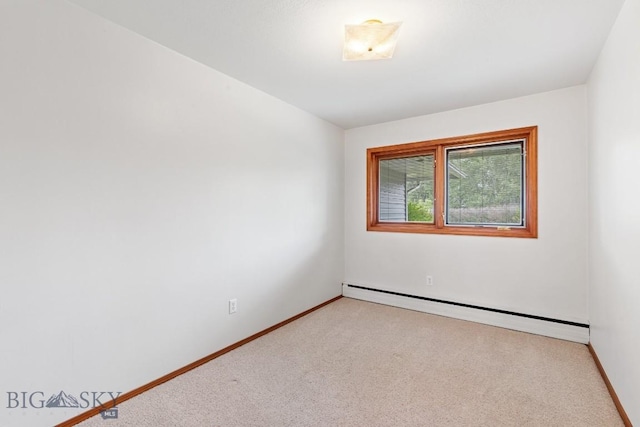 carpeted spare room featuring baseboard heating