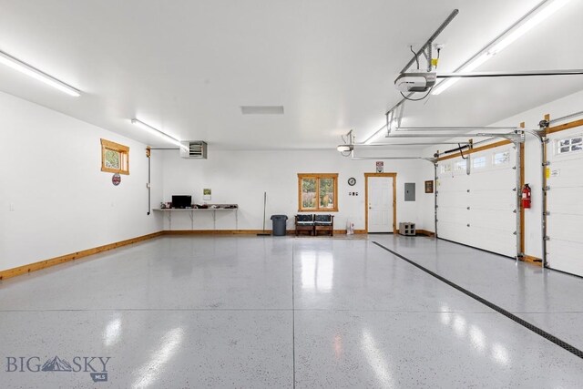 garage featuring electric panel and a garage door opener