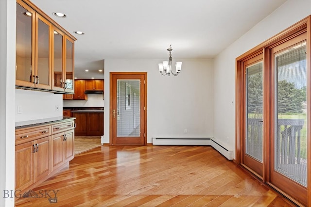 kitchen featuring decorative light fixtures, light hardwood / wood-style floors, french doors, and an inviting chandelier