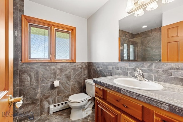 bathroom with toilet, tiled shower, baseboard heating, tile walls, and vanity