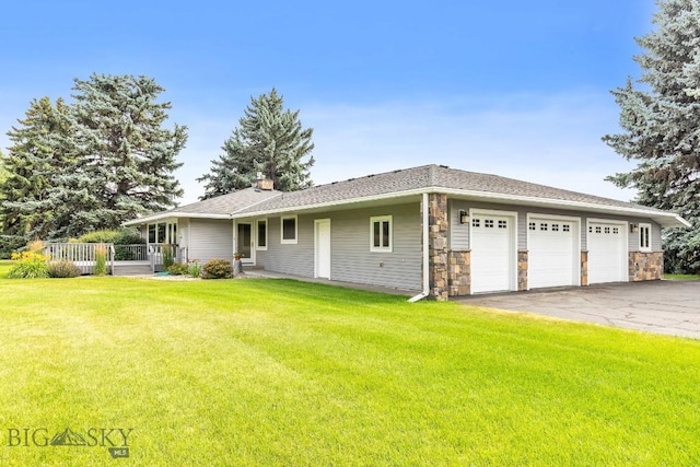 ranch-style home with a front lawn and a garage