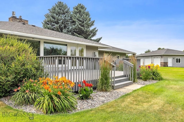 rear view of house featuring a deck and a yard