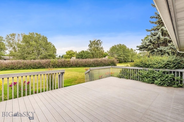 wooden terrace with a lawn