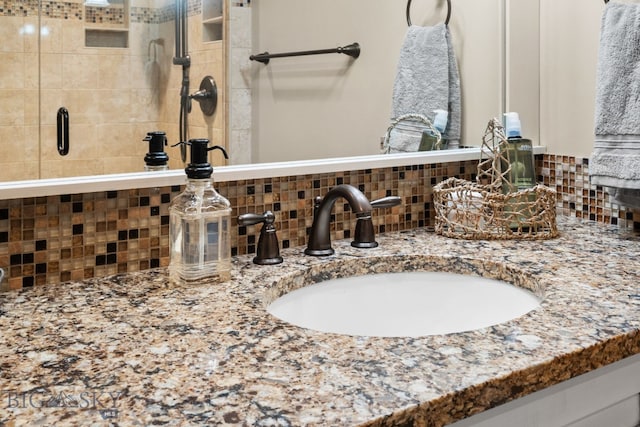 9 Park Plaza Rd, Bozeman, MT 59715 - details featuring vanity, a stall shower, and backsplash