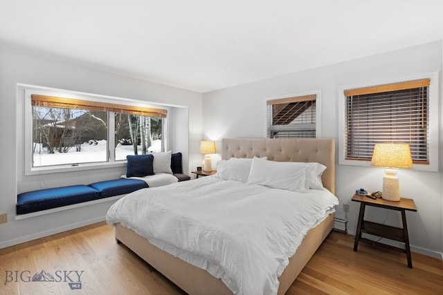 9 Park Plaza Rd, Bozeman, MT 59715 - bedroom with baseboards, a baseboard heating unit, and wood finished floors