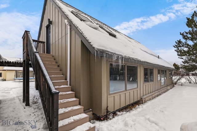 9 Park Plaza Rd, Bozeman, MT 59715 - view of snow covered exterior featuring board and batten siding and stairway