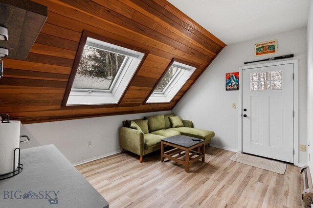 9 Park Plaza Rd, Bozeman, MT 59715 - living area with baseboards, light wood finished floors, and vaulted ceiling with skylight