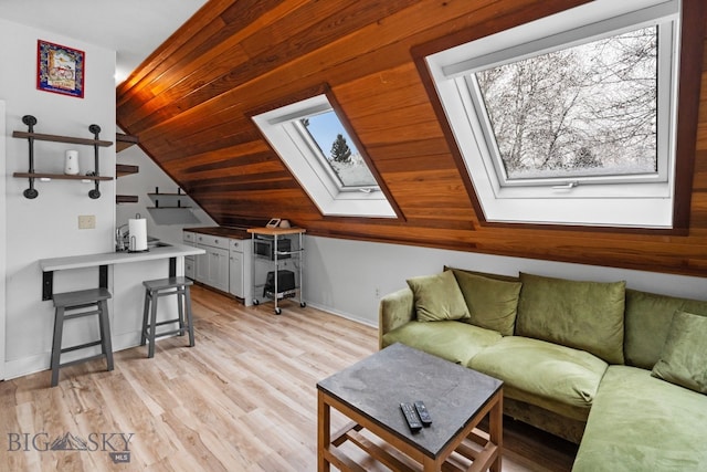 9 Park Plaza Rd, Bozeman, MT 59715 - living area featuring a skylight, vaulted ceiling, baseboards, and light wood finished floors